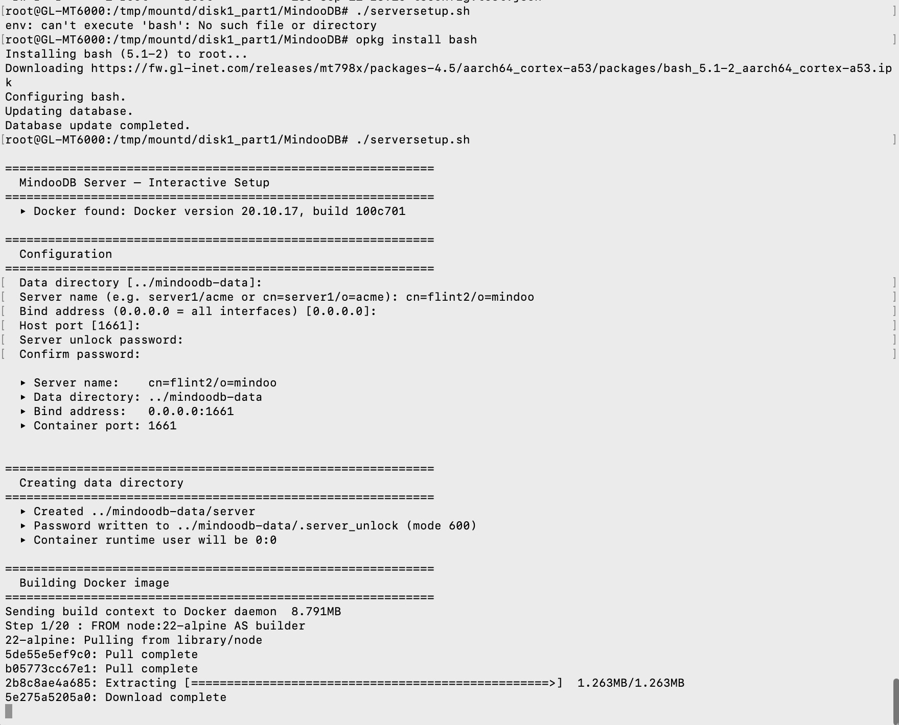 The terminal on the router: running ./serversetup.sh produces "env: can't execute 'bash': No such file or directory", then "opkg install bash" installs bash 5.1-2, and the second run of ./serversetup.sh prints the MindooDB Server interactive setup - "Docker found: Docker version 20.10.17, build 100c701", the configuration prompts for data directory, server name cn=flint2/o=mindoo, bind address 0.0.0.0 and host port 1661, the created data directory with the password file at mode 600 and container runtime user 0:0, and the start of the Docker build sending an 8.791 MB context and pulling node:22-alpine for step 1 of 20